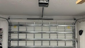 Inside face of a closed sectional door beneath its overhead opener