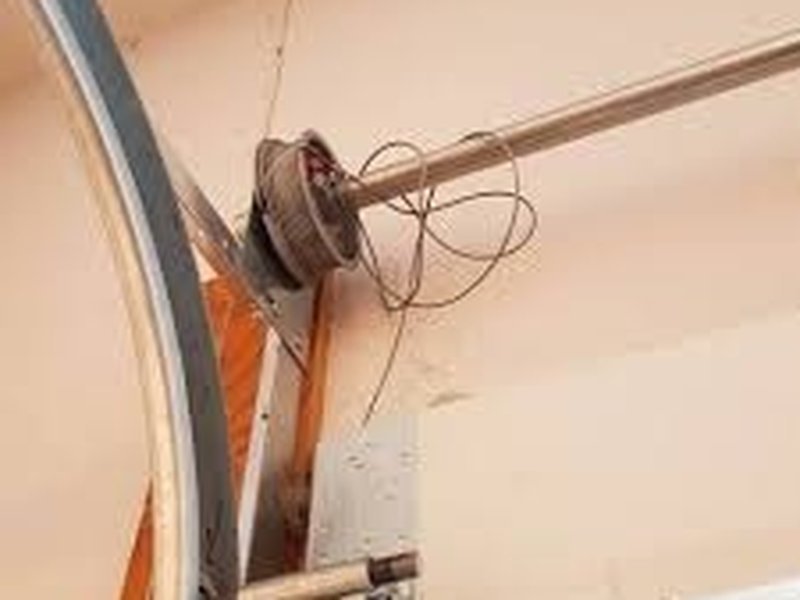 Cable wound around a drum at the end of a garage door shaft
