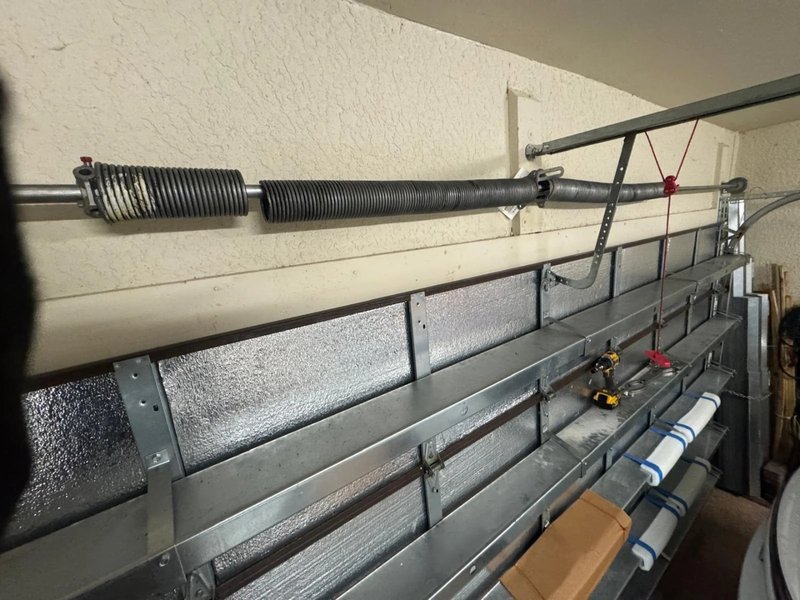 Spring and track hardware along the top of a garage door